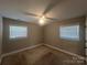 Comfortable bedroom with carpet, ceiling fan, and two windows for plenty of natural light at 1907 Steele St, Monroe, NC 28110