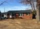 Quaint single-Gathering brick home features a covered carport and neat landscaping at 1907 Steele St, Monroe, NC 28110