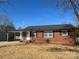 Charming brick home featuring a covered carport, manicured lawn and a classic design at 1907 Steele St, Monroe, NC 28110