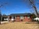 Charming brick house with a covered carport, a welcoming front door, and manicured landscaping at 1907 Steele St, Monroe, NC 28110