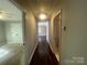 Long hallway with hardwood floors connects to rooms and creates a sense of flow and spaciousness at 1907 Steele St, Monroe, NC 28110