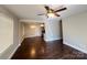 Inviting living room with dark wood floors, neutral paint, and a ceiling fan at 1907 Steele St, Monroe, NC 28110