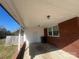 Covered back patio with brick accents, offering an outdoor space for relaxation and entertainment at 1907 Steele St, Monroe, NC 28110