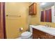 Bathroom with tan walls, wooden cabinets, and a toilet at 1976 Mcilwain Rd, Lancaster, SC 29720