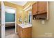 Bright bathroom featuring tan walls, wood cabinets, and a single sink vanity at 1976 Mcilwain Rd, Lancaster, SC 29720