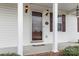 Inviting front entrance featuring a glass storm door, decorative lighting, and house number at 1976 Mcilwain Rd, Lancaster, SC 29720