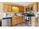 Galley kitchen with stainless steel appliances and wooden cabinets at 1976 Mcilwain Rd, Lancaster, SC 29720