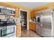 Efficient kitchen layout featuring stainless steel appliances, oak cabinets, and tiled floors at 1976 Mcilwain Rd, Lancaster, SC 29720