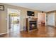 Cozy living room with hardwood floors, a fireplace, and open doorway to the kitchen at 1976 Mcilwain Rd, Lancaster, SC 29720