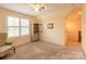 Spacious bedroom with carpeted floor, large window, and built-in shelving at 2349 Shiny Leaf Dr, Denver, NC 28037