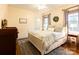 Bright bedroom with king-size bed, hardwood floors, and window seating at 2349 Shiny Leaf Dr, Denver, NC 28037