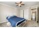 Spacious bedroom with a blue bedspread, ceiling fan, and access to another room at 27 Quayside Ct, Clover, SC 29710