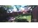 A spacious backyard with a tall wooden fence and lush green grass, offering privacy and room for outdoor activities at 327 Coxe Ave, Charlotte, NC 28208