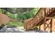 An inviting backyard with a cozy patio, a staircase leading to a deck, and ambient string lighting at 327 Coxe Ave, Charlotte, NC 28208