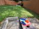 Grass yard with cornhole game and patio at 327 Coxe Ave, Charlotte, NC 28208