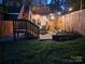 Evening view of patio, string lights, and firepit at 327 Coxe Ave, Charlotte, NC 28208