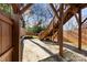 Brick patio with wooden stairs, shade structure, and fenced yard at 327 Coxe Ave, Charlotte, NC 28208