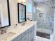 Stunning bathroom with double sinks, gray cabinetry, quartz countertops, and a glass enclosed walk-in shower at 327 Coxe Ave, Charlotte, NC 28208