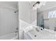 Bright bathroom with a shower-tub combo featuring white subway tiles, sleek white vanity, and modern fixtures at 327 Coxe Ave, Charlotte, NC 28208