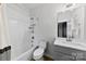 Cozy bathroom features a shower-tub combo, a toilet, and a vanity with a mirror at 327 Coxe Ave, Charlotte, NC 28208