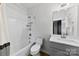 Bright bathroom featuring a tub, shower, vanity, and tile accents at 327 Coxe Ave, Charlotte, NC 28208