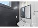 Modern bathroom with dark shiplap walls and a pedestal sink at 327 Coxe Ave, Charlotte, NC 28208