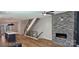 Bright, modern living room with hardwood floors, a fireplace, and open access to the kitchen at 327 Coxe Ave, Charlotte, NC 28208