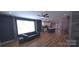 Modern living room with hardwood floors, a comfortable couch, and open access to the kitchen at 327 Coxe Ave, Charlotte, NC 28208