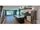 Open-concept living space featuring a kitchen with an island, and modern lighting at 327 Coxe Ave, Charlotte, NC 28208