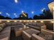 Rooftop deck with sectional sofa and string lights at night at 327 Coxe Ave, Charlotte, NC 28208