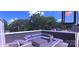 A rooftop deck is showcased, furnished with a plush sectional sofa and table under ambient string lights at 327 Coxe Ave, Charlotte, NC 28208
