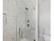 Contemporary shower with marble-style tile, glass enclosure, rainfall showerhead, and built-in niche for toiletries at 327 Coxe Ave, Charlotte, NC 28208
