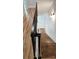 Modern staircase with hardwood treads, white risers, black iron railing, and sleek lighting for a contemporary look at 327 Coxe Ave, Charlotte, NC 28208