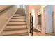 Staircase with wooden treads and black metal railing leading to a landing with built-in storage at 327 Coxe Ave, Charlotte, NC 28208