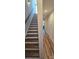This stairway features hardwood steps and white risers, complemented by a light wood handrail and neutral walls at 327 Coxe Ave, Charlotte, NC 28208