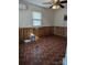 Bright bedroom with wood paneled walls and tile flooring at 3798 Providence Mill Rd, Maiden, NC 28650