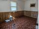 Bright bedroom with wood paneled walls and tile flooring at 3798 Providence Mill Rd, Maiden, NC 28650