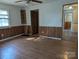 Spacious living room featuring wood-paneled walls and laminate flooring at 3798 Providence Mill Rd, Maiden, NC 28650