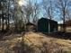 Green barn and covered structure in the backyard at 3798 Providence Mill Rd, Maiden, NC 28650