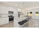 Modern kitchen with island, white cabinets, and granite countertops at 4039 Northerly Island Ct, Gastonia, NC 28056