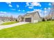 Ranch home with 2-car garage, showcasing a side view and beautifully landscaped yard at 423 Granite Lake Ct, Denver, NC 28037