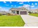 One-story home with brown garage door and manicured lawn at 423 Granite Lake Ct, Denver, NC 28037