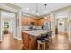 Modern kitchen with an island, wooden cabinets, and granite countertops at 423 Granite Lake Ct, Denver, NC 28037