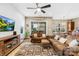 Living room with hardwood floors, sectional sofa, and access to a screened porch at 423 Granite Lake Ct, Denver, NC 28037