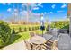 The stone patio features an outdoor table and grill, perfect for entertaining on a sunny day at 423 Granite Lake Ct, Denver, NC 28037