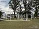 A beautiful common area in the neighborhood with a circular stone patio, a fire pit, and mature trees for shade at 444 Berryman Rd, Rock Hill, SC 29732