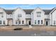 New construction townhome featuring farmhouse-style design, light-colored wood beams, and a landscaped front yard at 444 Berryman Rd, Rock Hill, SC 29732