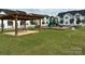 New community playground with picnic tables and wooden pergola, surrounded by lush green grass at 444 Berryman Rd, Rock Hill, SC 29732