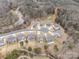 Aerial view of a cul-de-sac with single-Gathering homes near a river, and the house has green tree surround at 4551 Selhurst Dr, Indian Land, SC 29707