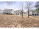 Backyard view of two-story home with a fenced-in yard, patio, and minimal landscaping at 4551 Selhurst Dr, Indian Land, SC 29707